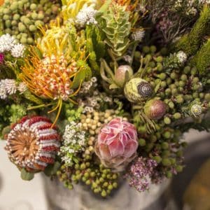 African Soul bouquet with wild greenery and organic textures, bold and natural floral arrangement.