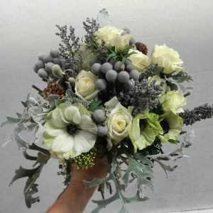 Winter Bouquet made with fresh seasonal flowers, including anemones, brunias, and roses. Elegant and sophisticated floral arrangement.
